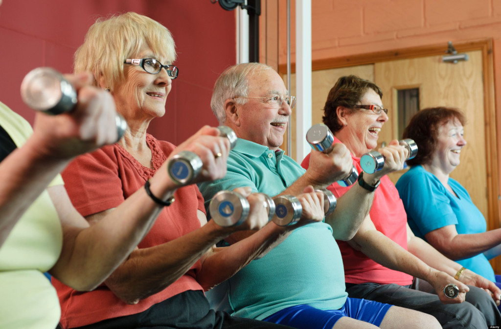 Older people lifting weights in gym