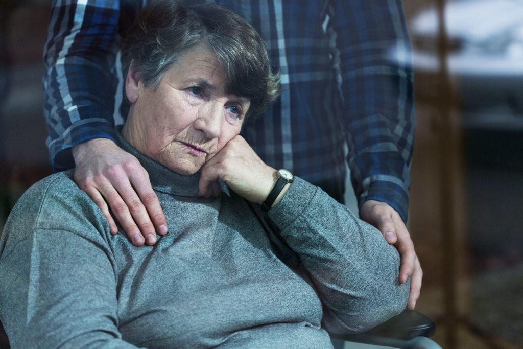 Son comforts depressed mother.