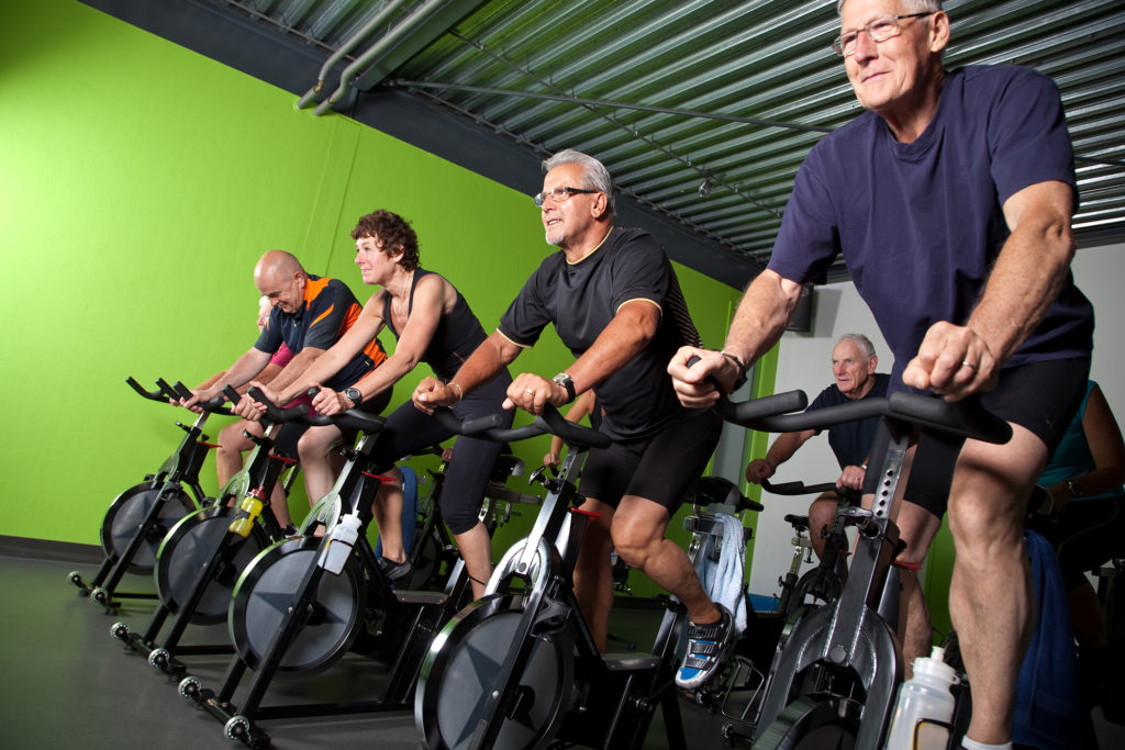 Group of seniors cycling in a spinning class