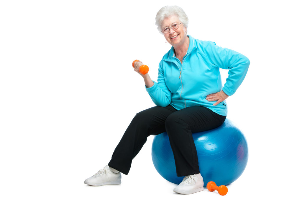 Smiling senior woman in fitness training with dumbbells
