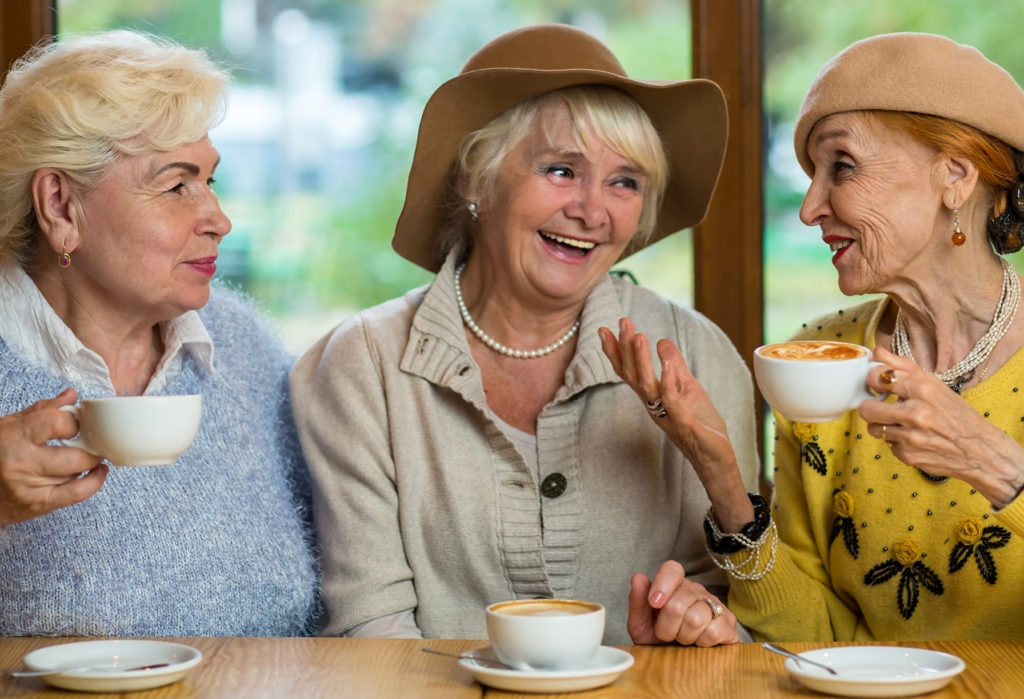 Happy seniors enjoying conversation in a cafe.