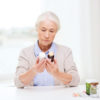 Senior Woman comparing medicine label instructions.