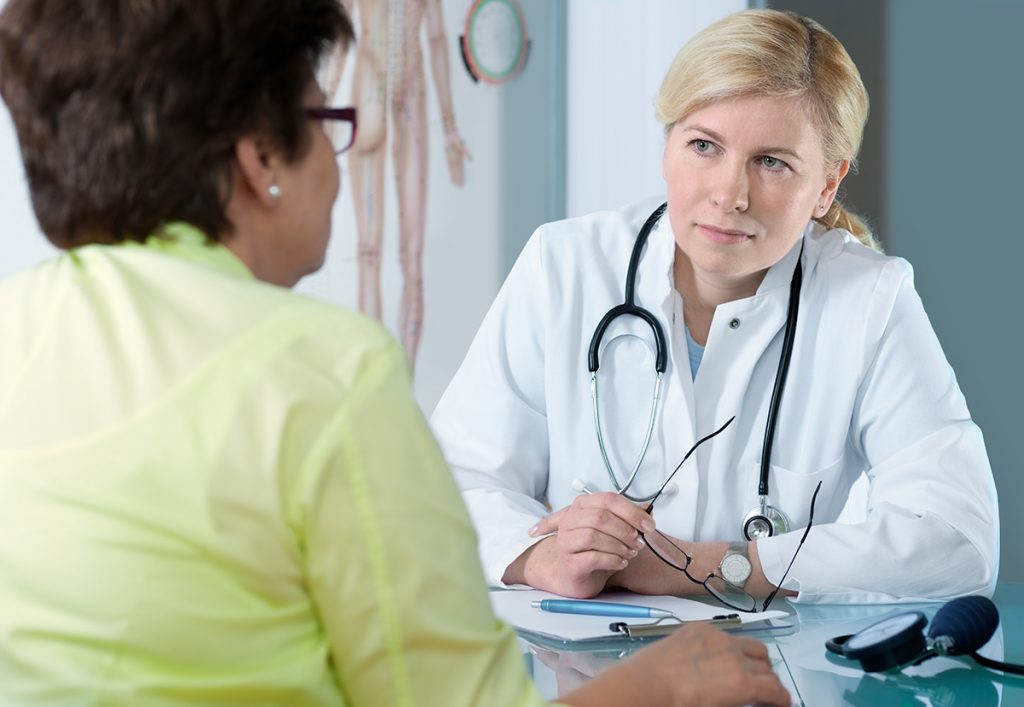 Senior patient discussing medical problems with concerned physician.