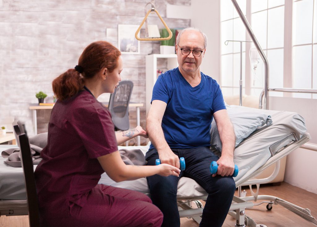 Young female doctor helping senior patient.