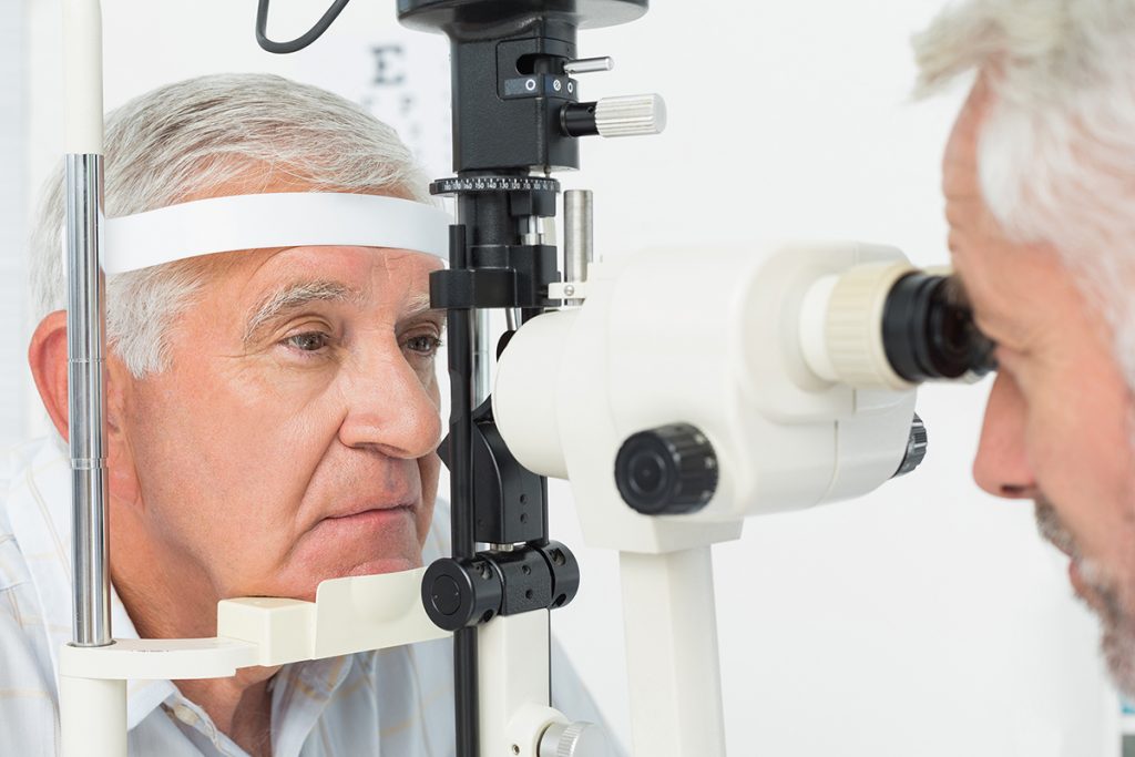 Senior Man getting an annual eye exam at the optometrist's offic.e