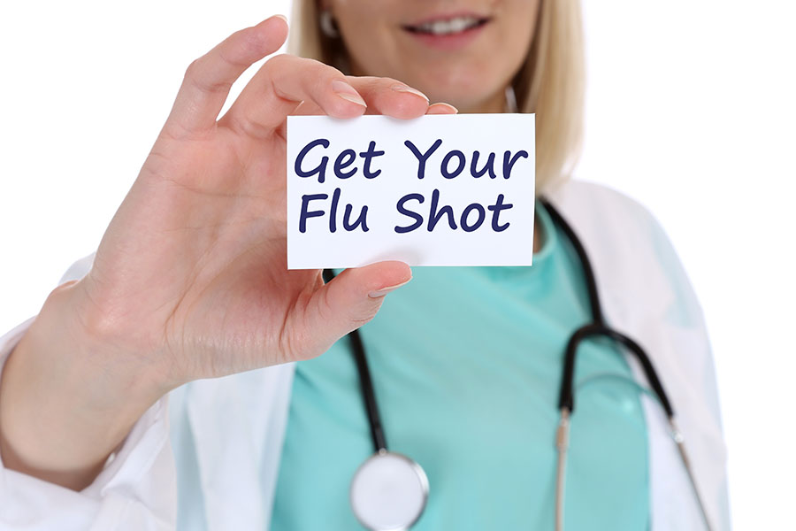 Nurse holding Get Your Flu Shot card.