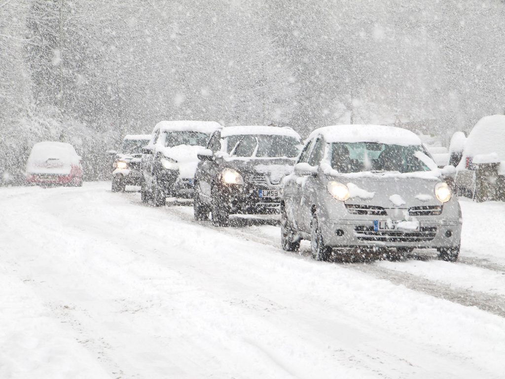 Bumper-to-bumper driving in a blizzard.