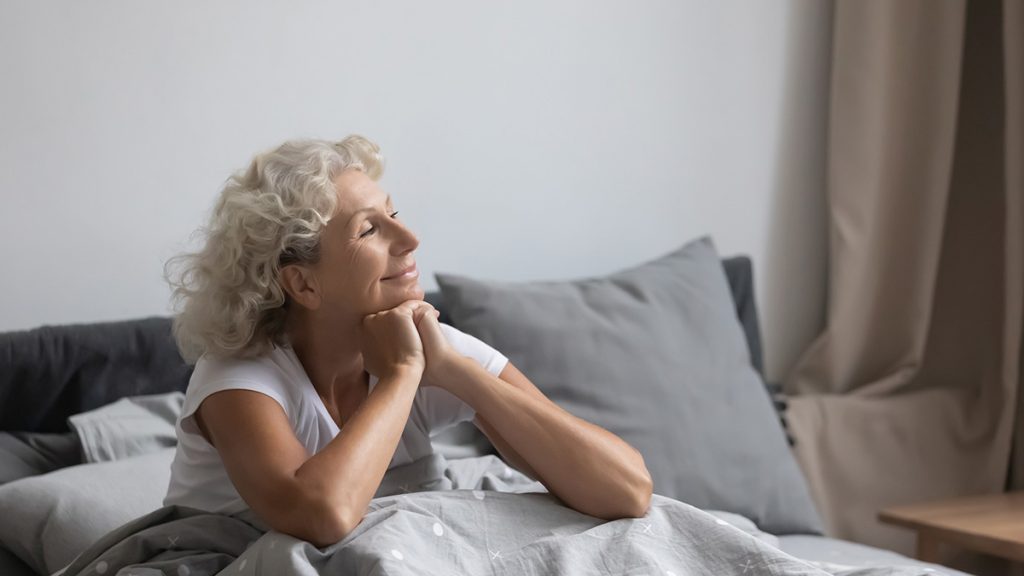 Senior woman waking up relaxed in the morning.