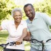 Senior African American couple cycling in park