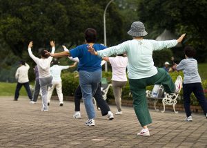 Elderly Women participating in a Tai Chi class which can help them manage pain and stiffness.