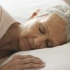 Woman peacefully sleeping in bed.