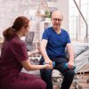 Young female doctor helping senior patient.