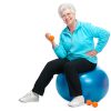 Happy senior woman using exercise ball and hand weights to improve fitness.