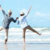 Two happy seniors dancing on the beach.