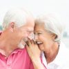 Senior couple smiling with heads together.